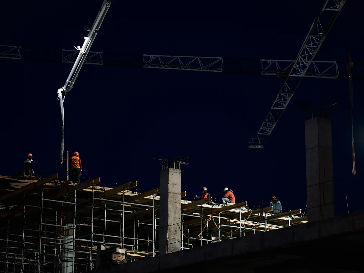 Installation crew working on an elevated structure at night