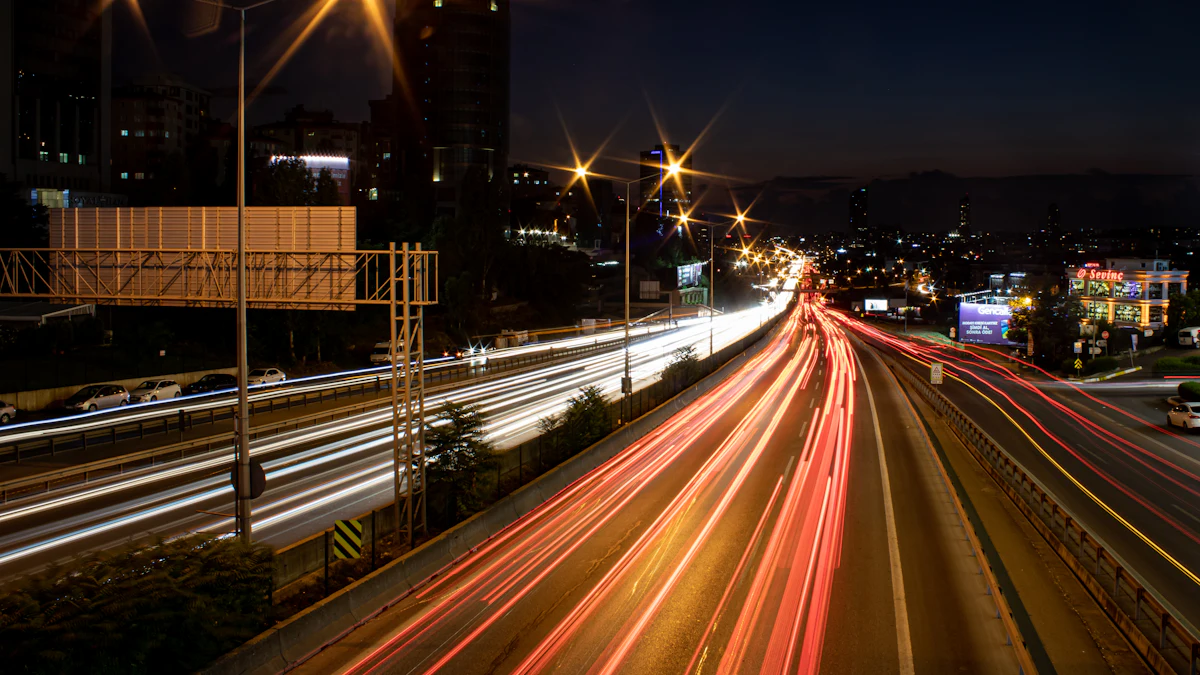 Night traffic corridor with overhead structures and light trails