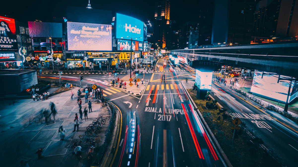City intersection at night surrounded by illuminated billboards