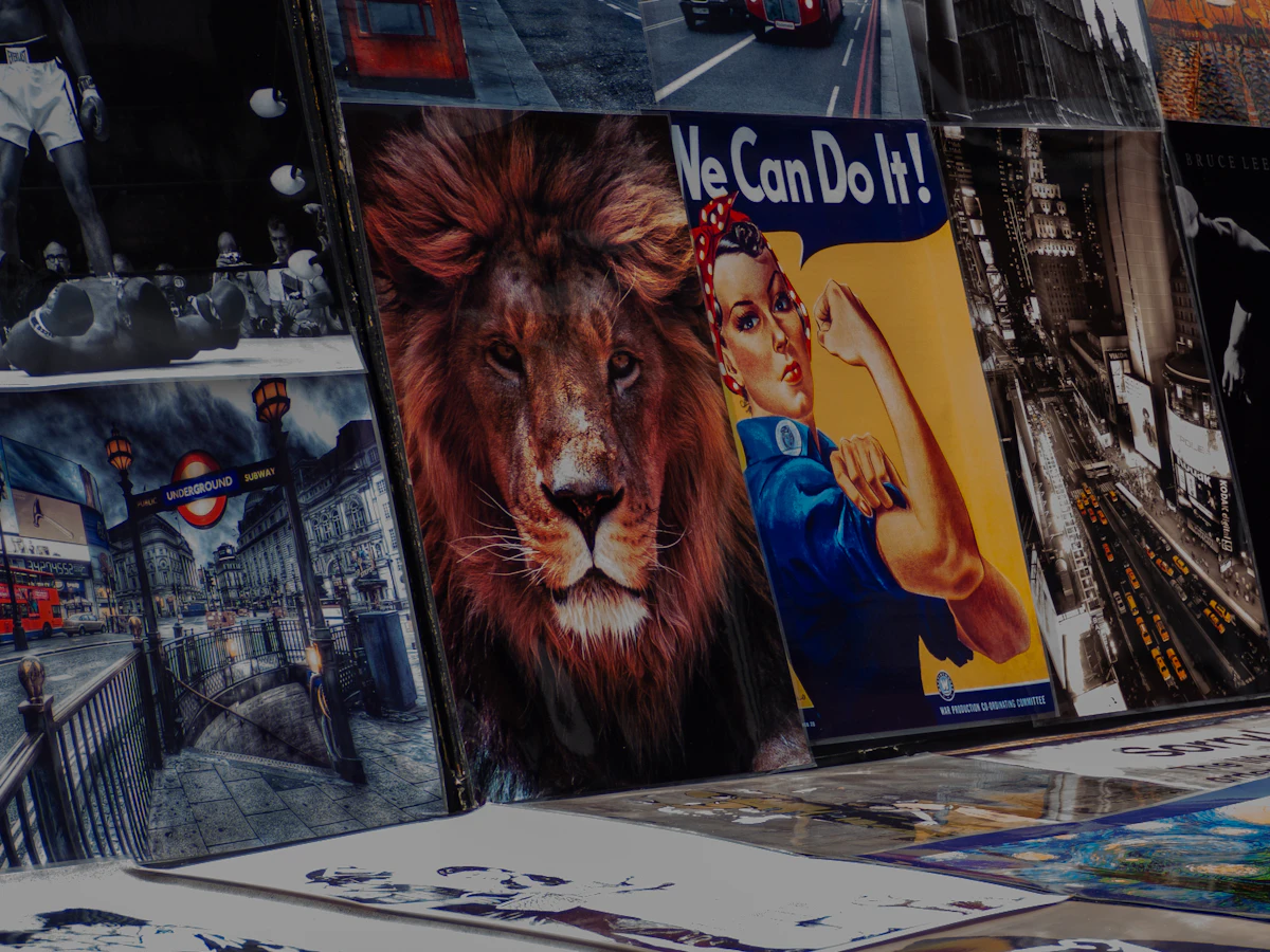 Large-format printed posters stacked in a production workshop